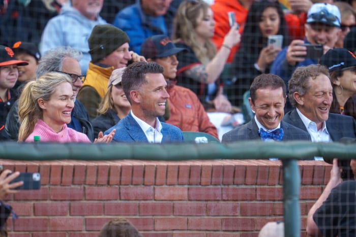 Legendary SF Giants catcher Buster Posey sits in the stands with Kristen Posey (left) and Ken Rosenthal (right).